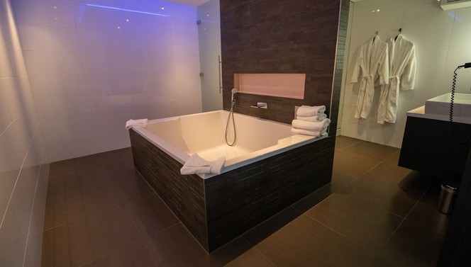 Bathroom with bath and shower